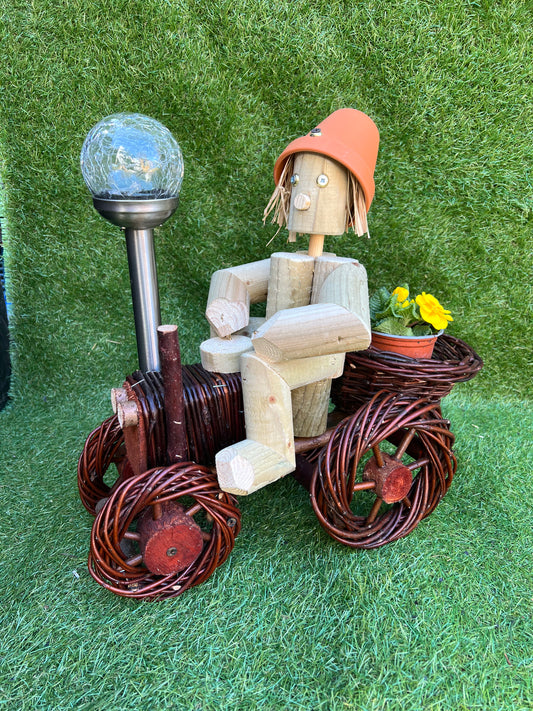 Man on a small dark wika tractor with solar light