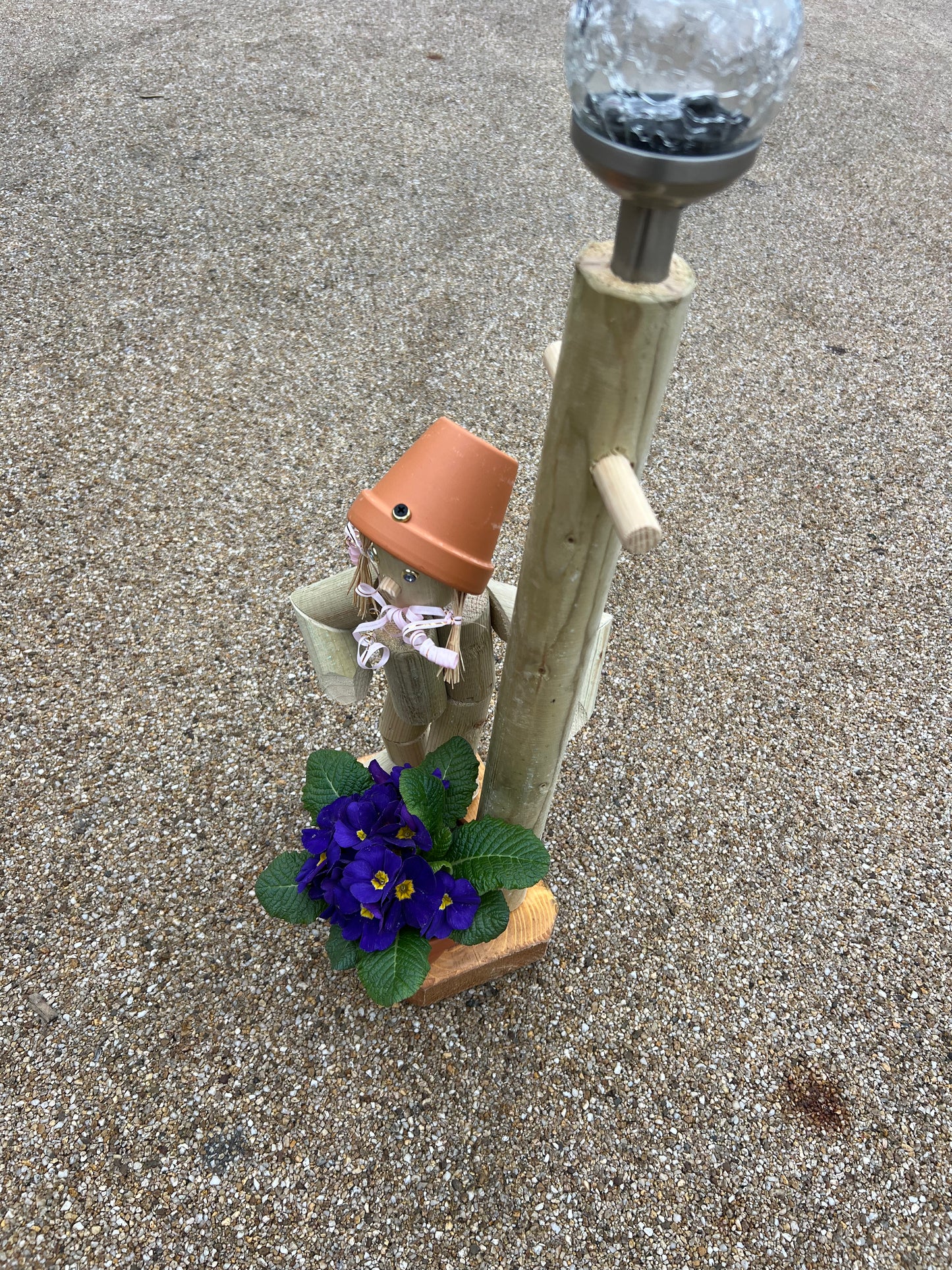 Little girl or boy with a tall lamp post