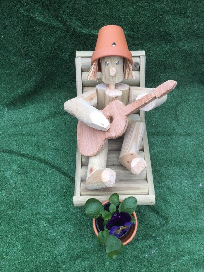 Man on a deckchair with guitar