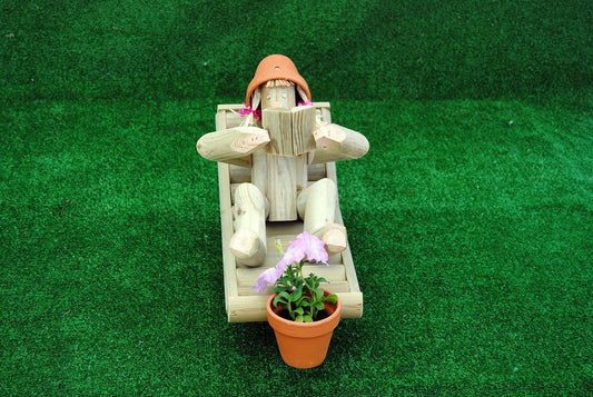 Girl on a deckchair reading a book