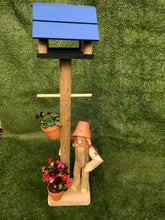 Girl or boy with bird feeder