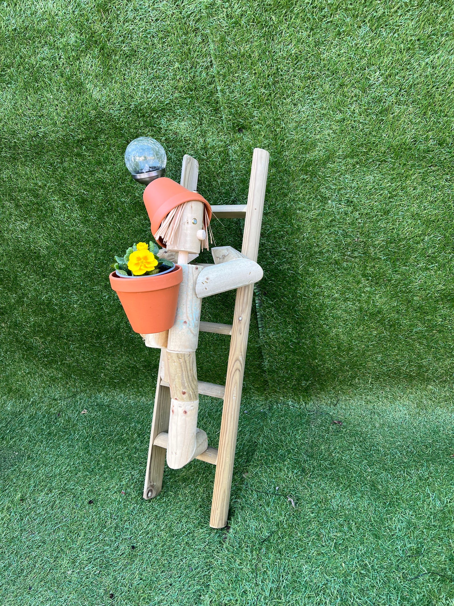 Girl or boy climbing a ladder with a solar lamp