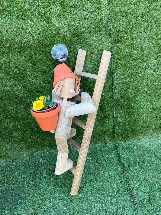 Girl or boy climbing a ladder with a solar lamp