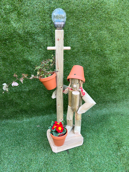 Girl or boy with a tall lamp post