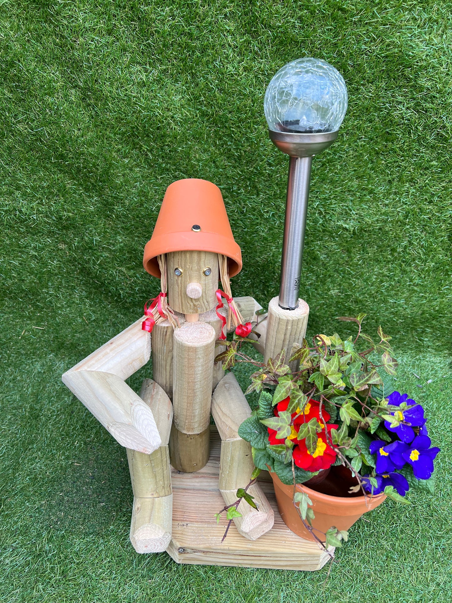 Sitting girl holding a pot with solar light