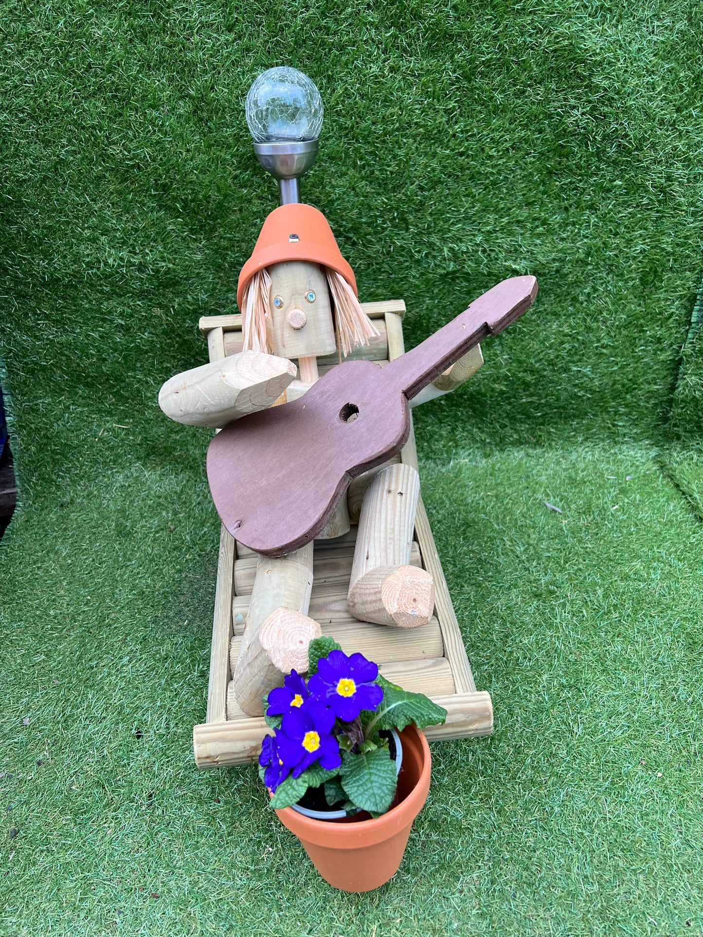 Man on a deckchair with guitar with solar light