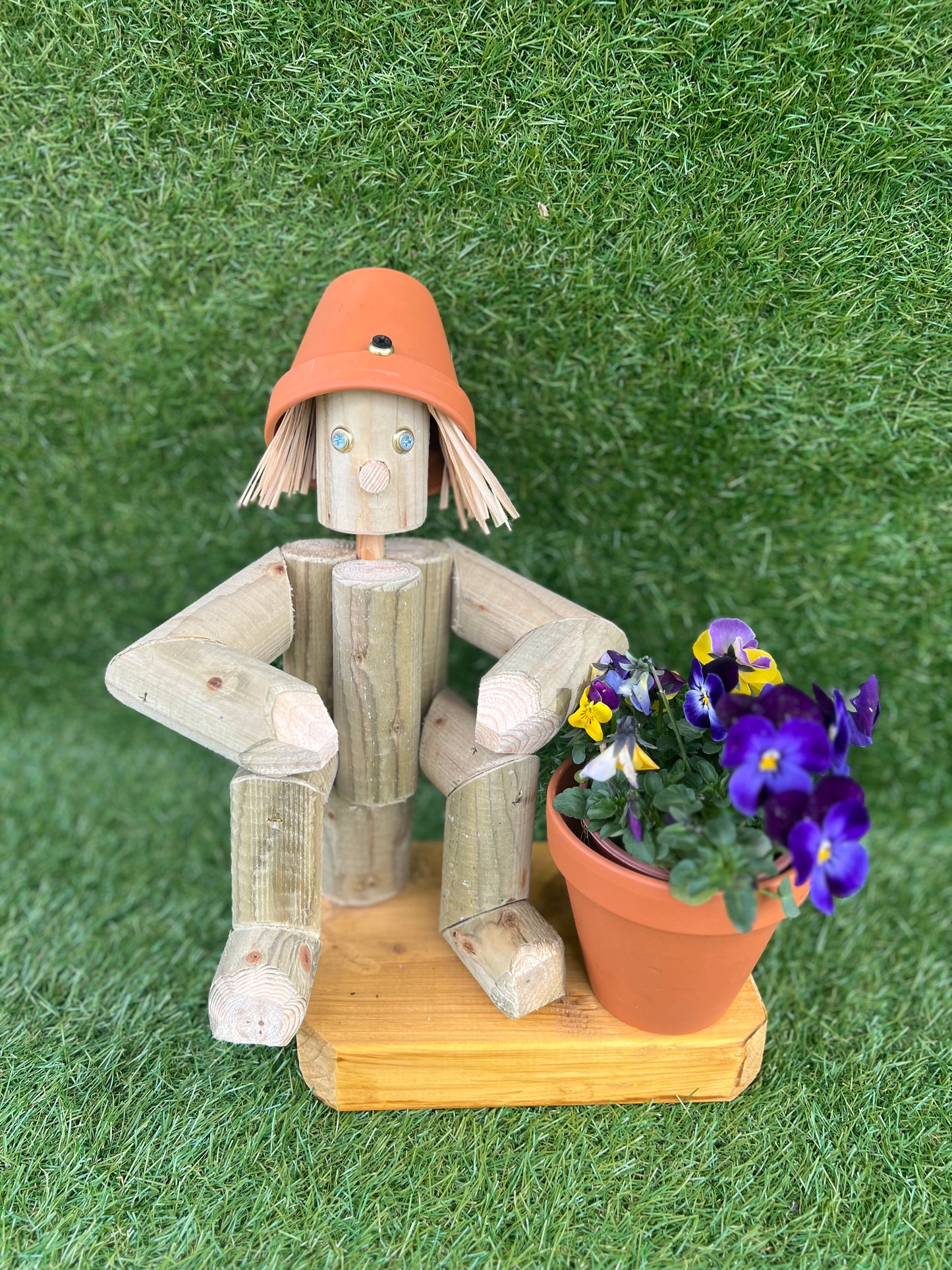 Small,sitting girl holding a pot