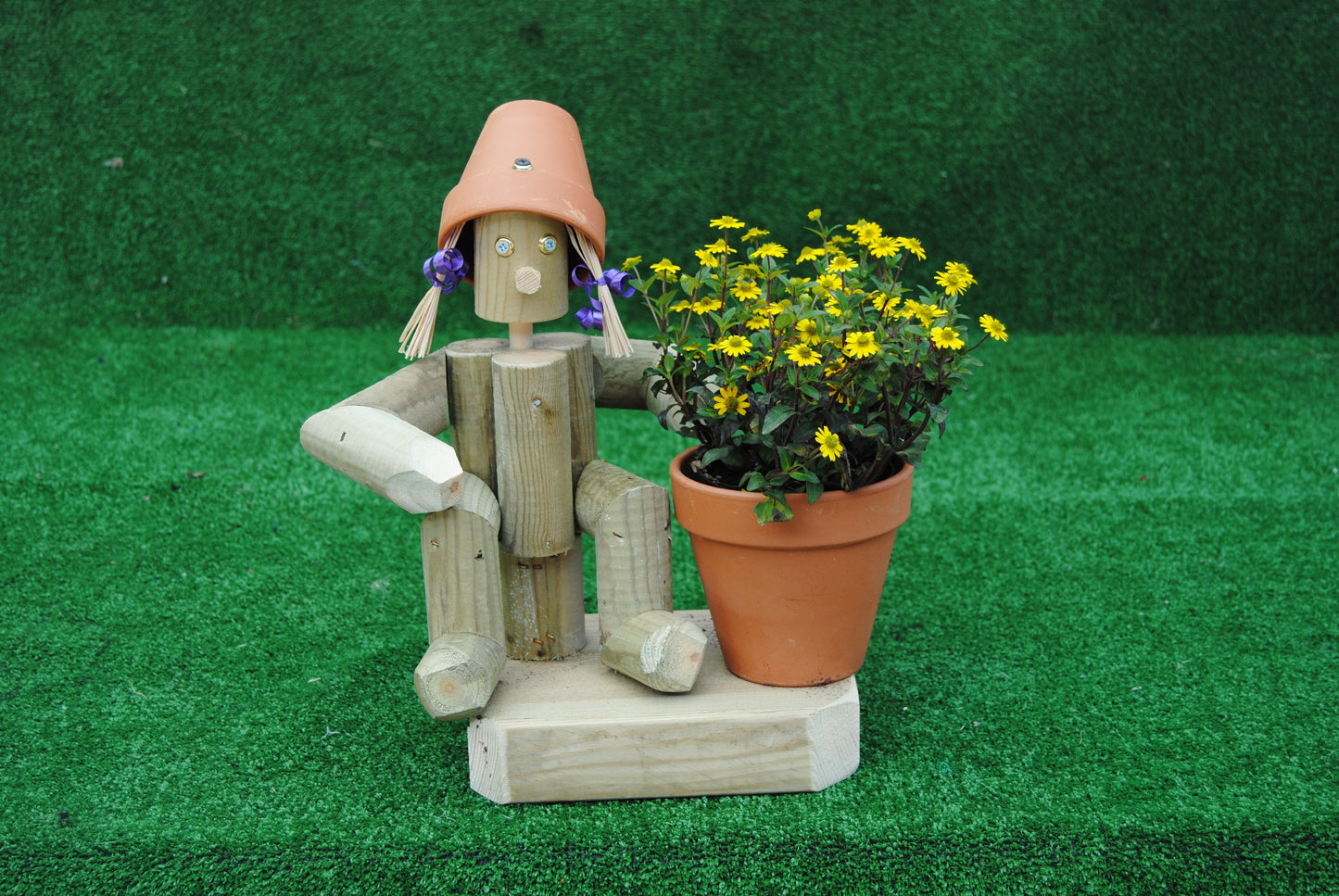 Small,sitting girl holding a pot