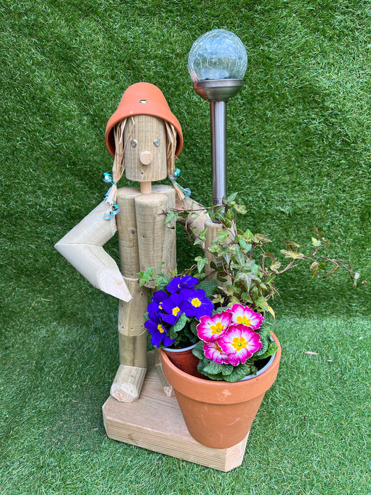 Standing girl or boy holding a pot with a solar light