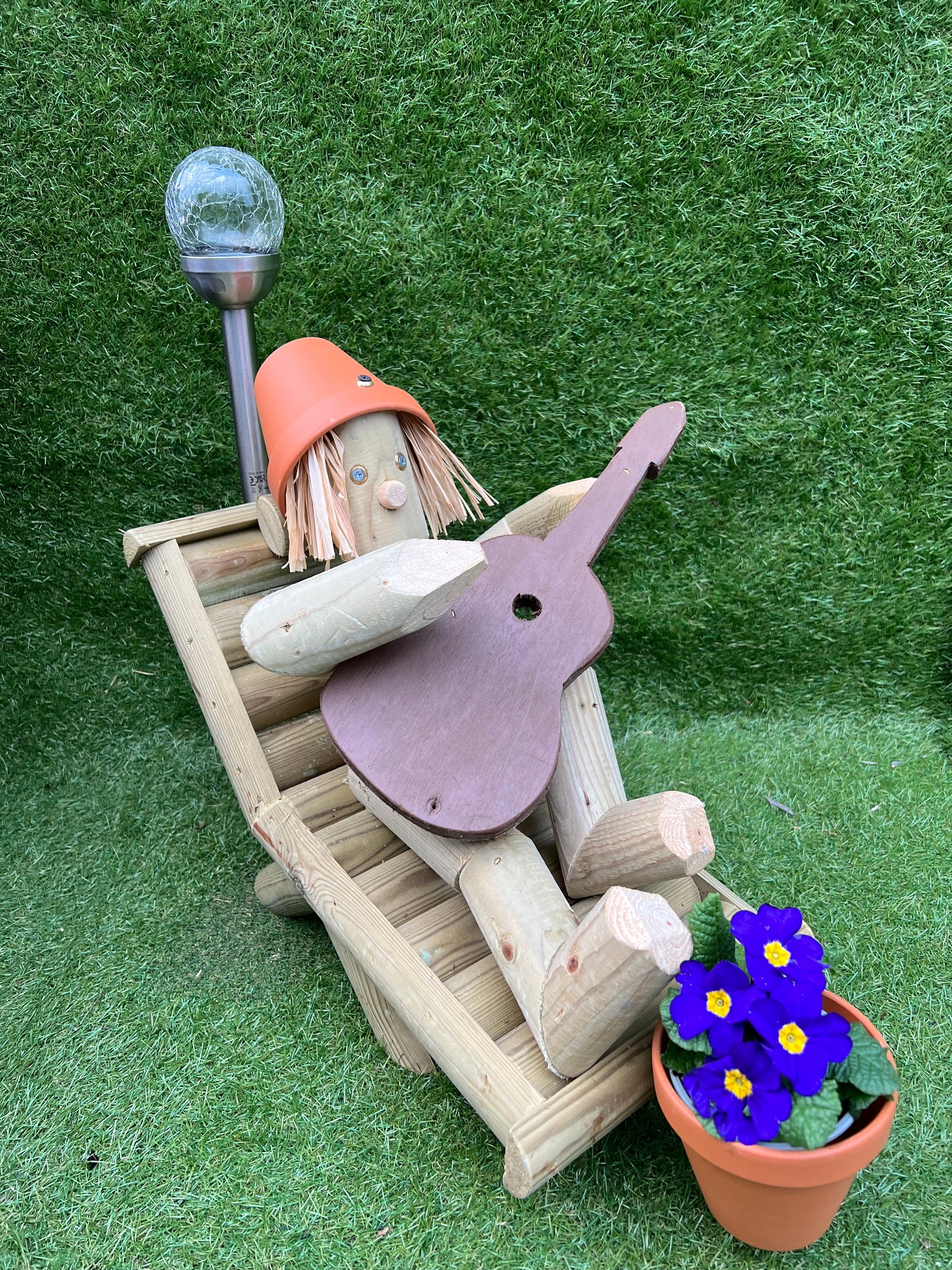 Man on a deckchair with guitar with solar light